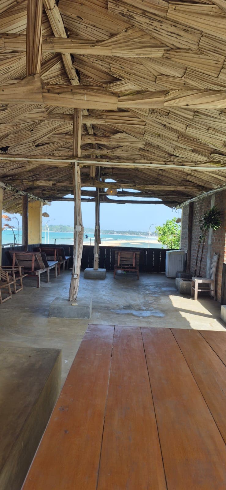 Deluxe room with palm-leaf walls and golden light