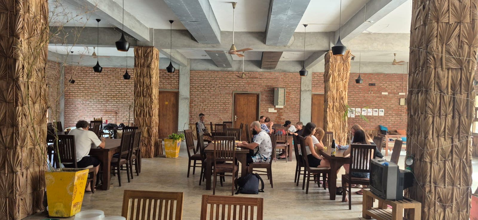 Rooftop bar with ocean view and wooden furniture