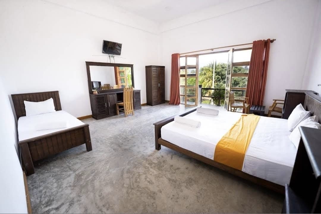 Guest room with palm-leaf wall decor and warm lighting