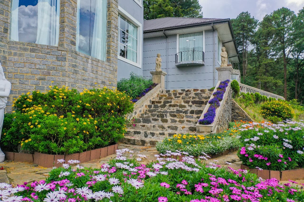 Front lawn with landscaped garden and mountain backdrop